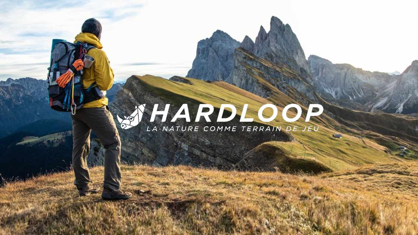 Hardloop — a hiker facing the mountains, with the retailer's logo