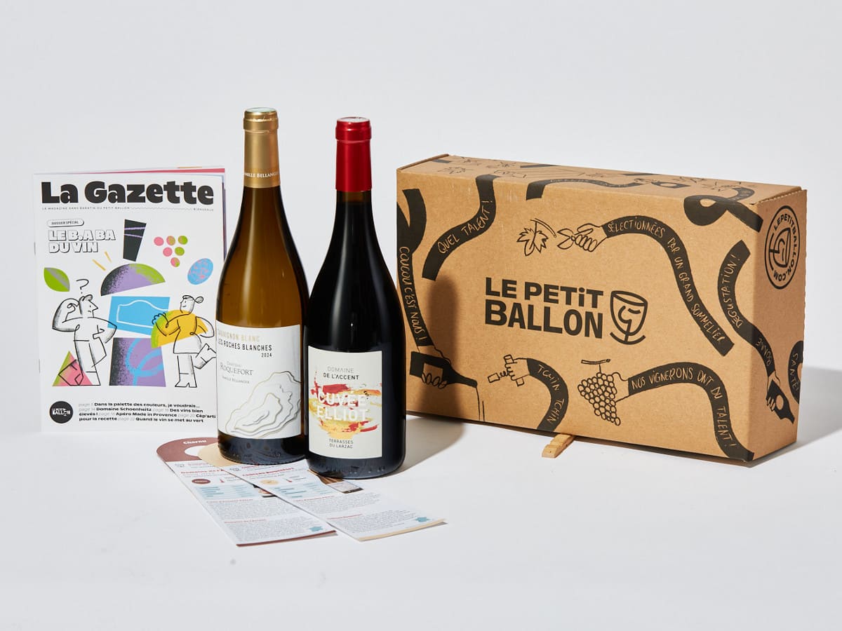 An open Le Petit Ballon box next to two bottles of wine and the La Gazette magazine