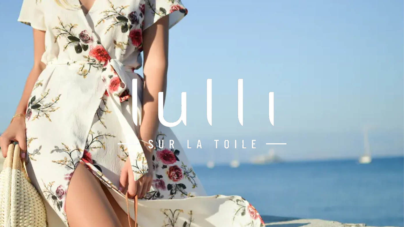Lulli sur la Toile — a floral dress by the sea, with the retailer's logo